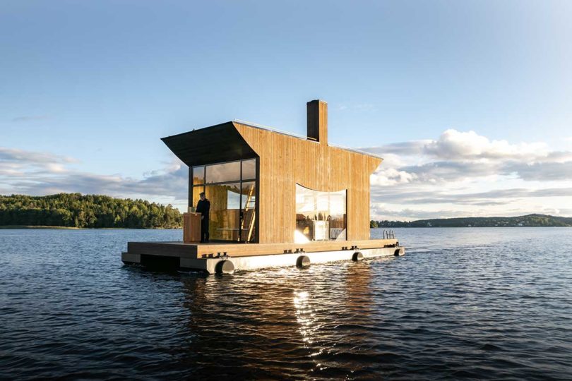 angled view of modern wooden floating sauna on water