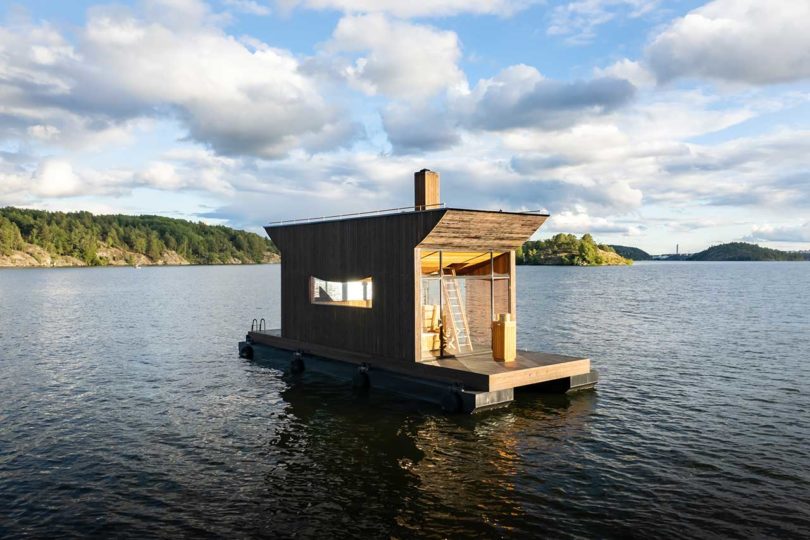 modern wooden floating sauna on water