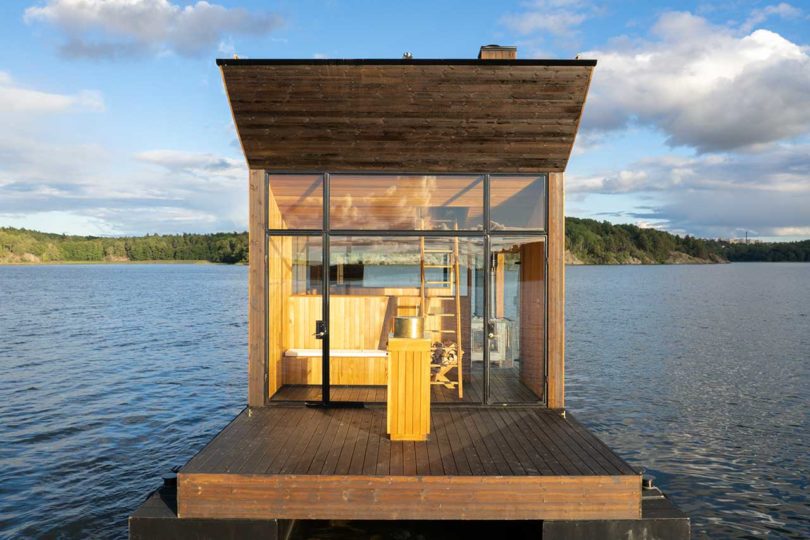 end view of modern wooden floating sauna on water