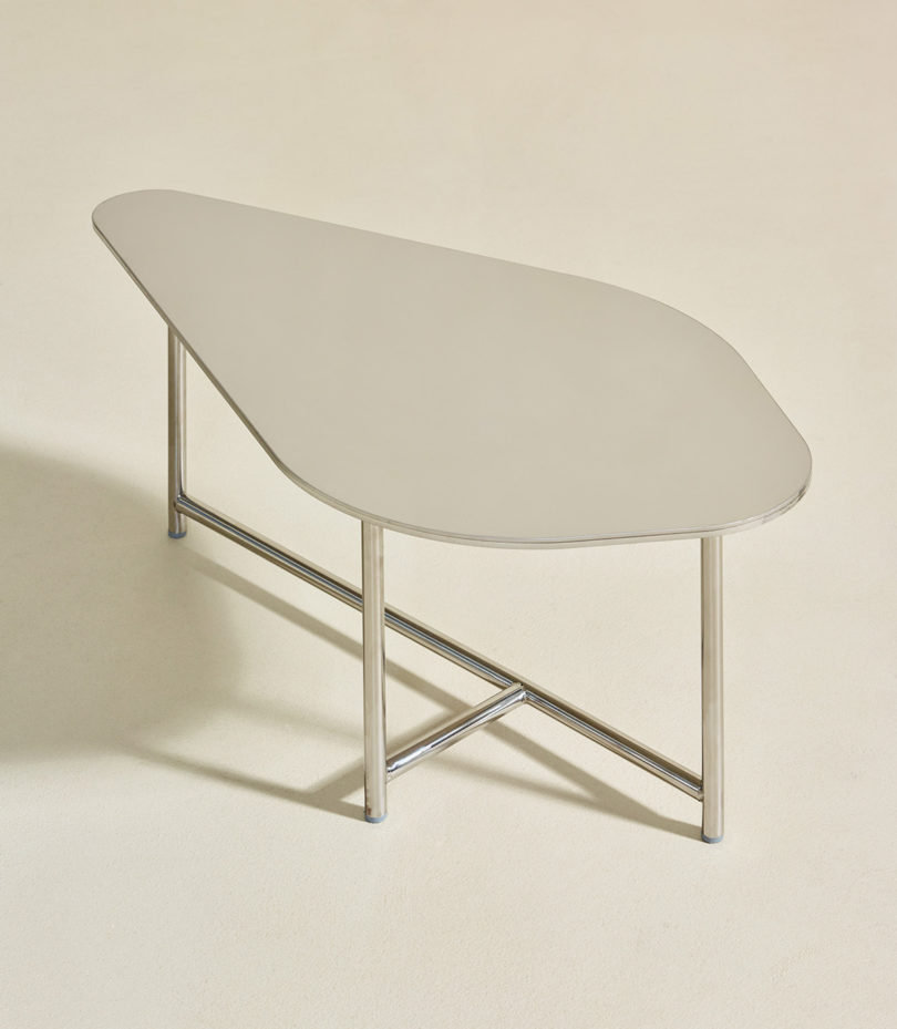 abstract shaped dining table with three legs