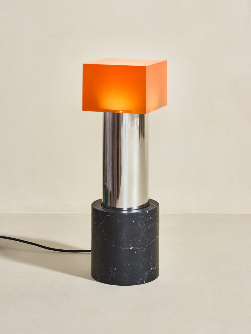 modern lighting with marble base and orange "shade"