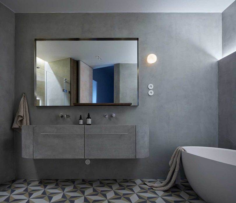 dark gray moody bathroom in modern apartment