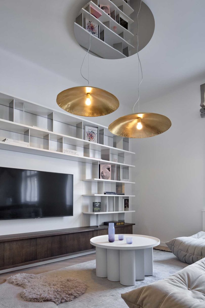 angled interior view of modern apartment with wall mounted bookshelves