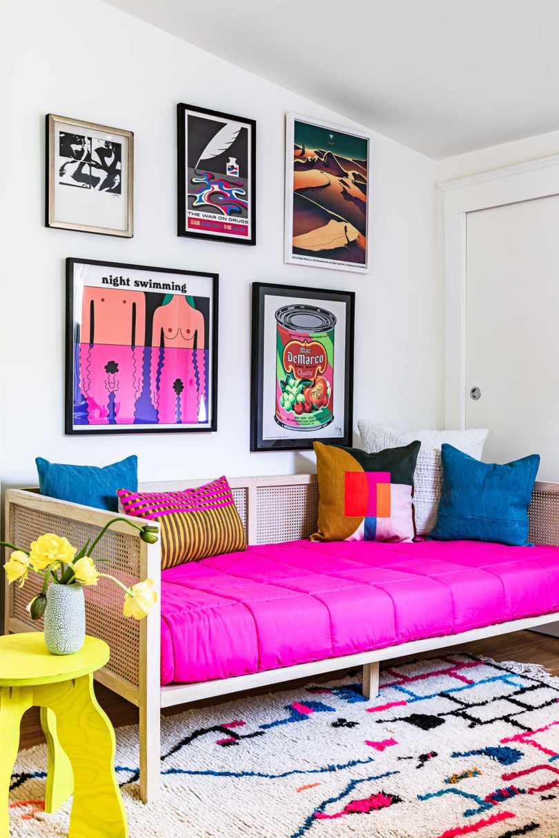 modern room with neon pink daybed and colorful art on the wall