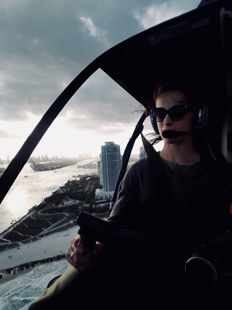 light-skinned woman piloting a helicopter