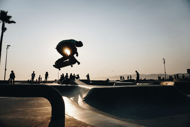 silhouette of a person riding a skateboard in a bowl