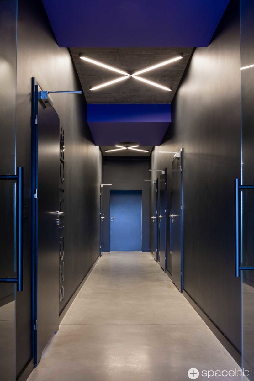 modern office interior with bold purple accents and black walls and doors