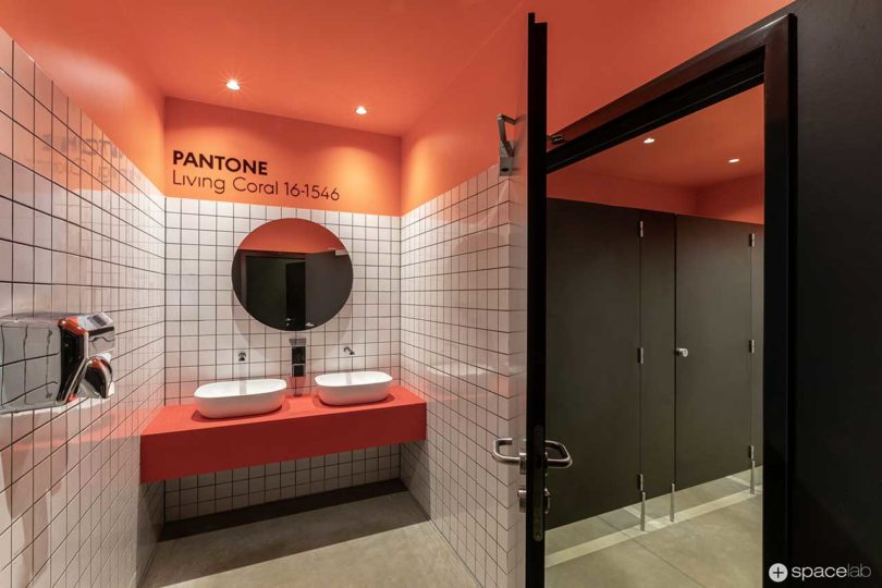 modern office bathroom with Pantone coral accents