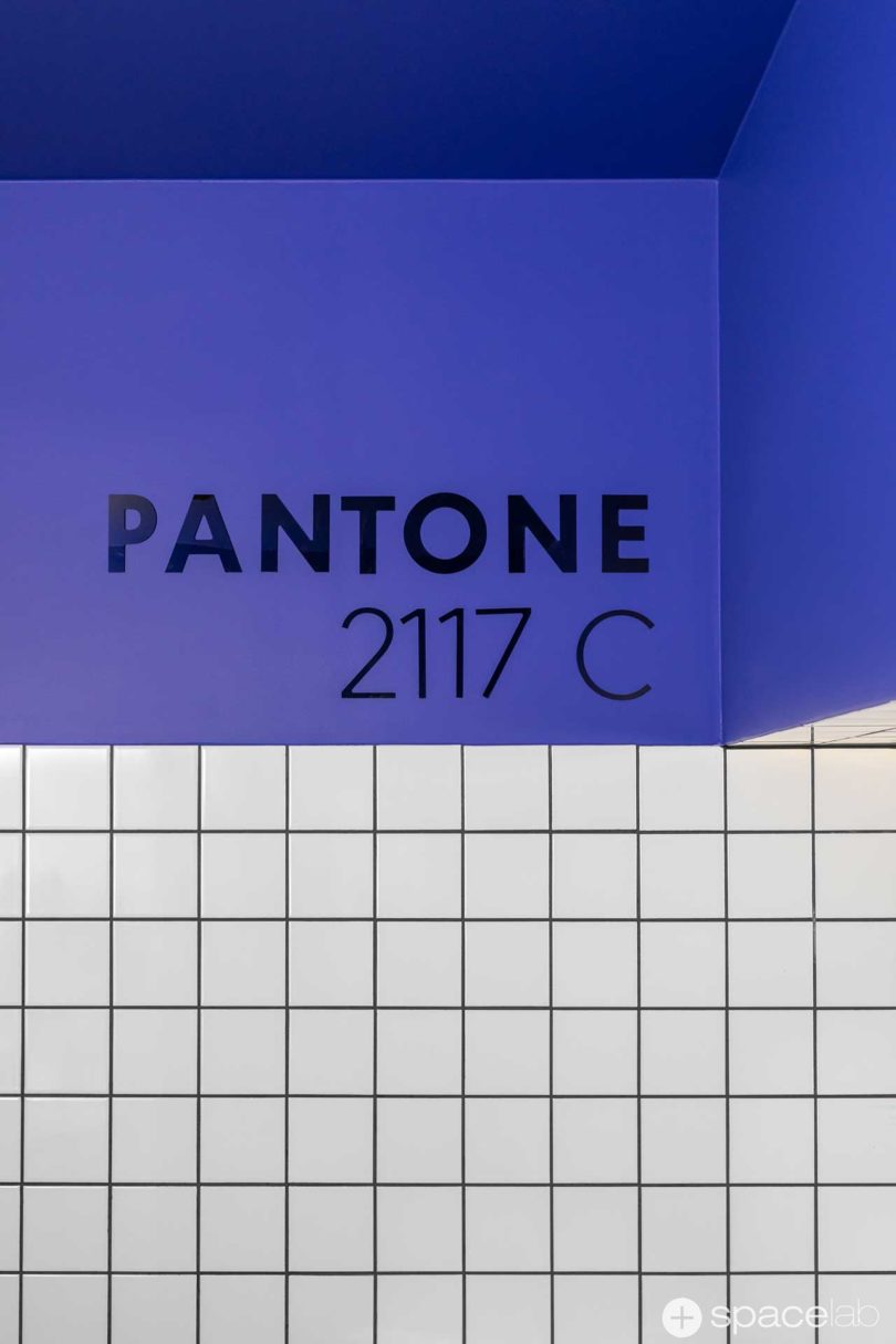 modern office bathroom with Pantone 2117C accents