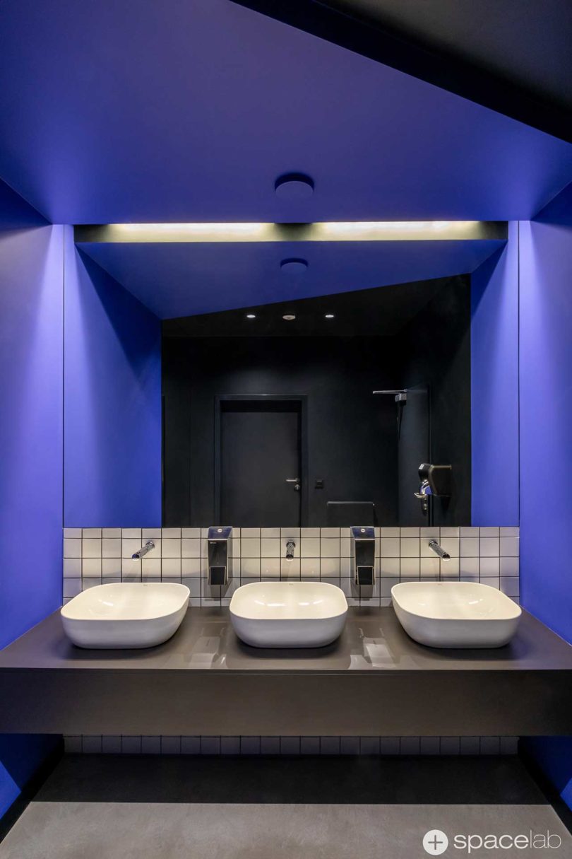 modern office bathroom with Pantone 2117C accents