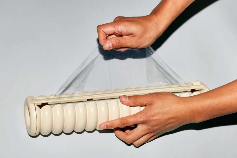 cling wrap being pulled out of beige holder