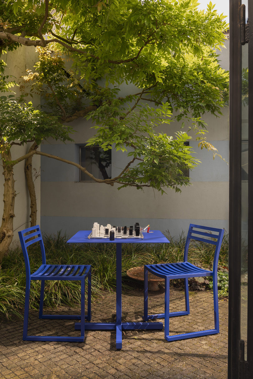 styled electric blue cafe table and two chairs outdoors