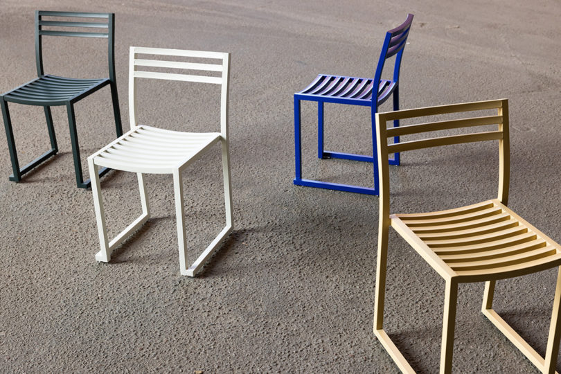 graphite, light grey, electric blue, and beige outdoor chairs on pavement
