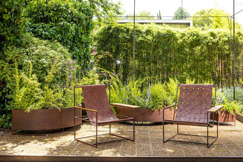 two brown leather slingback armchairs on an outdoor deck