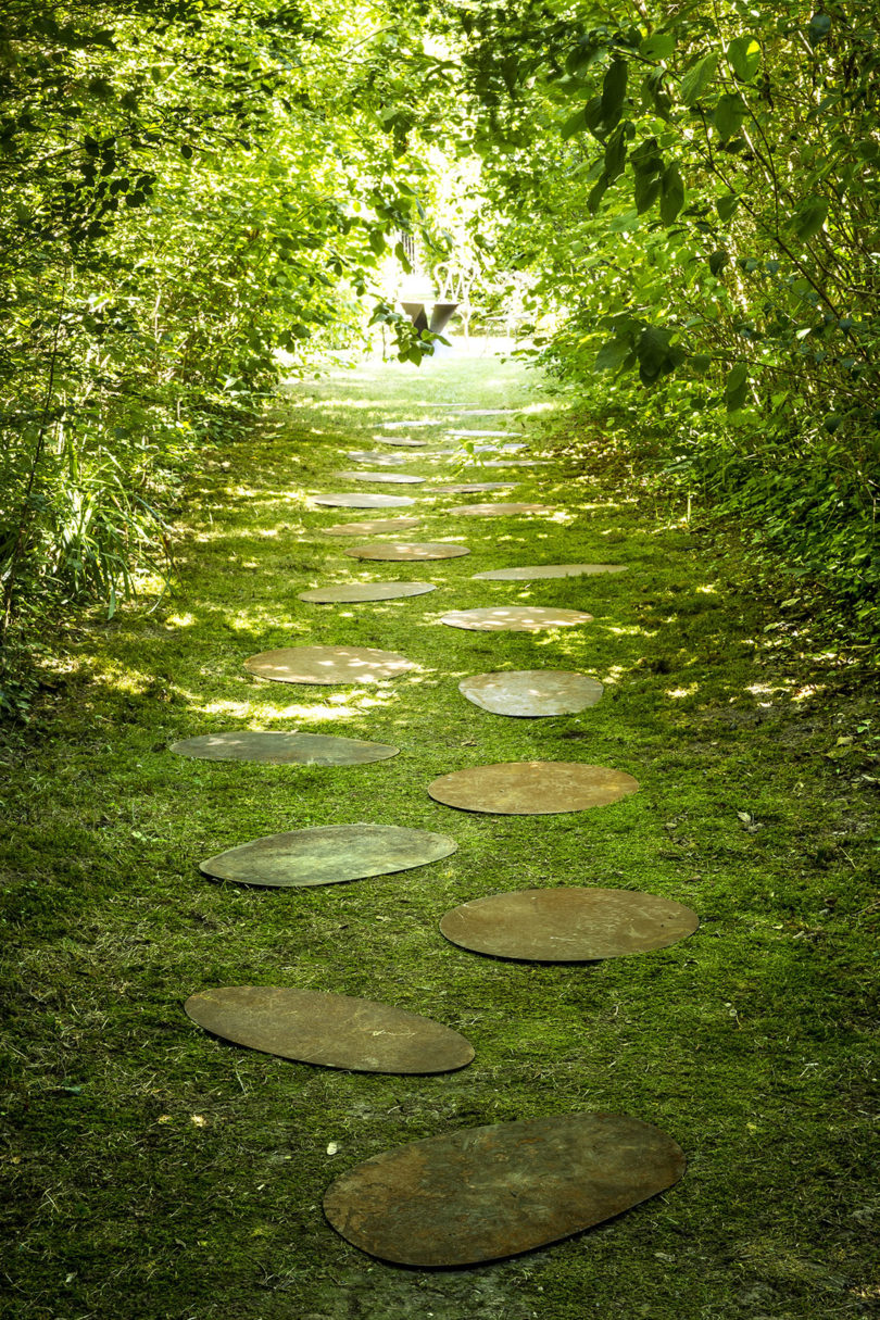 tree-lined grass path studded with stepping stones