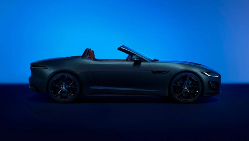 Side view of Jaguar 75 Edition F-TYPE sports car against glowing blue background.