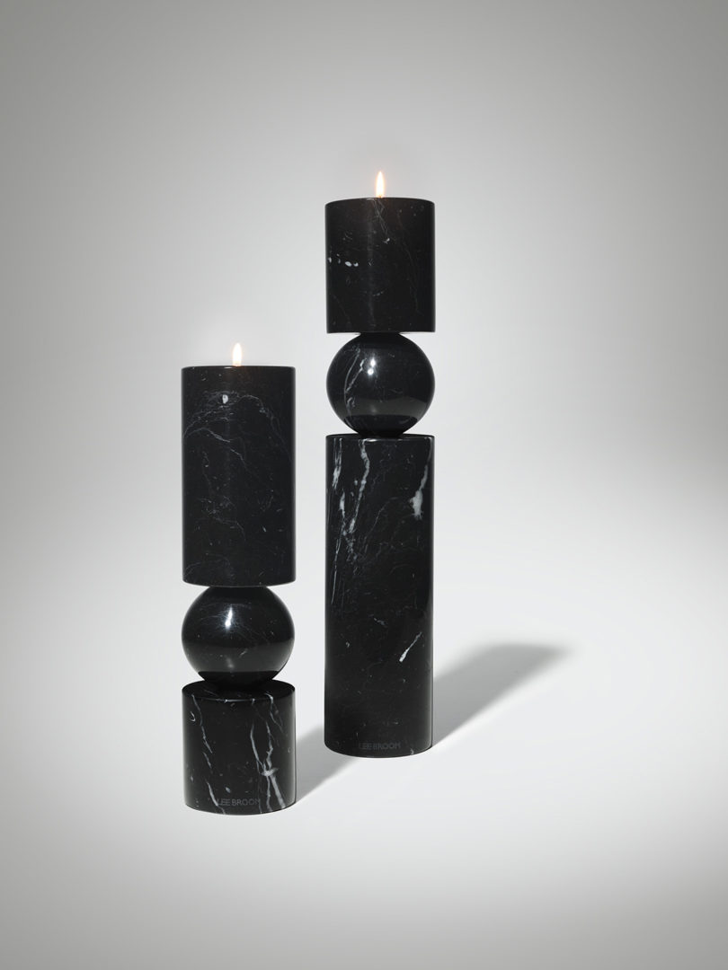 two black marble candlesticks in two heights on white background