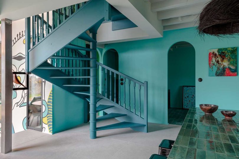 view of open turquoise staircase in modern home