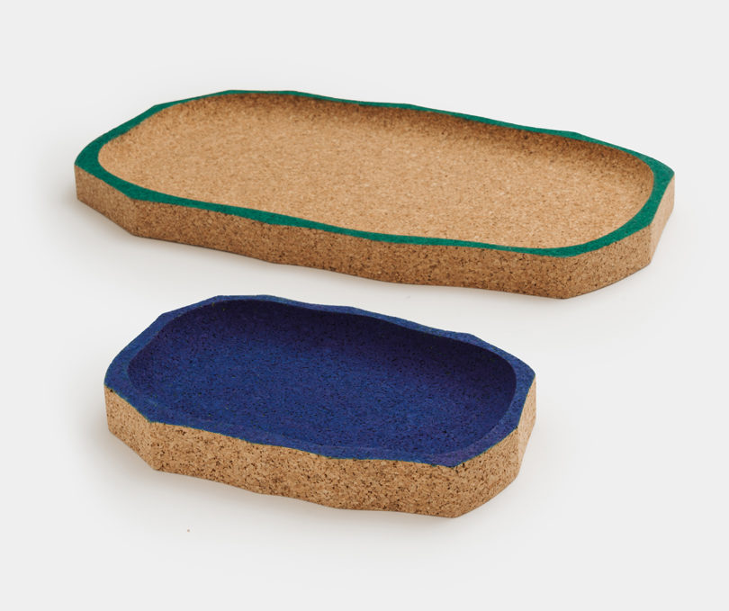 two cork trays, one with a navy blue interior and the other with green edging