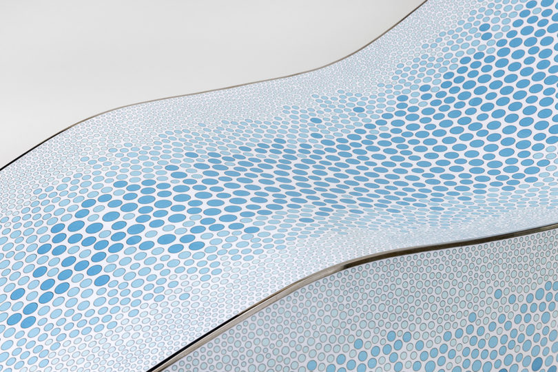 detail of curved lounge with blue pattern on white on a white background