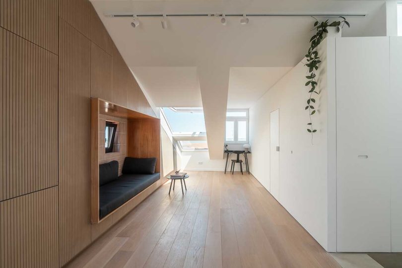 attic apartment with slanted ceilings and built-in sofa