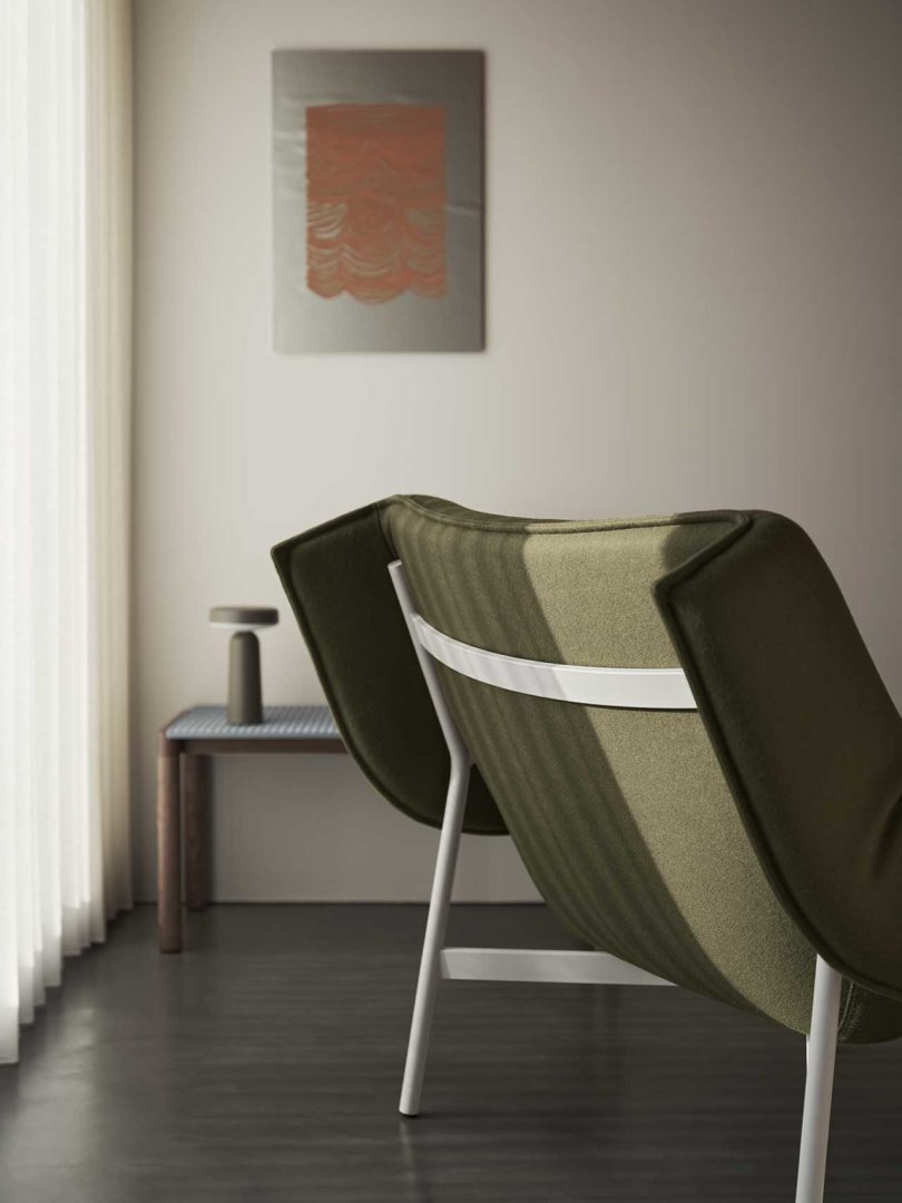 large pouffy green lounge chair in styled interior space