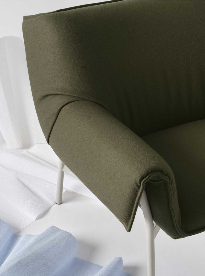 detail of large pouffy dark green lounge chair