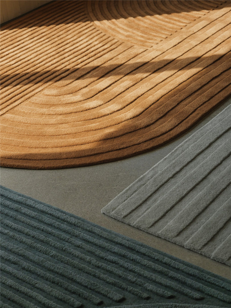 Detail of rounded corner of Revolo rug in Burnt Orange, illustrating how light and shadow interplay across its wool surface.