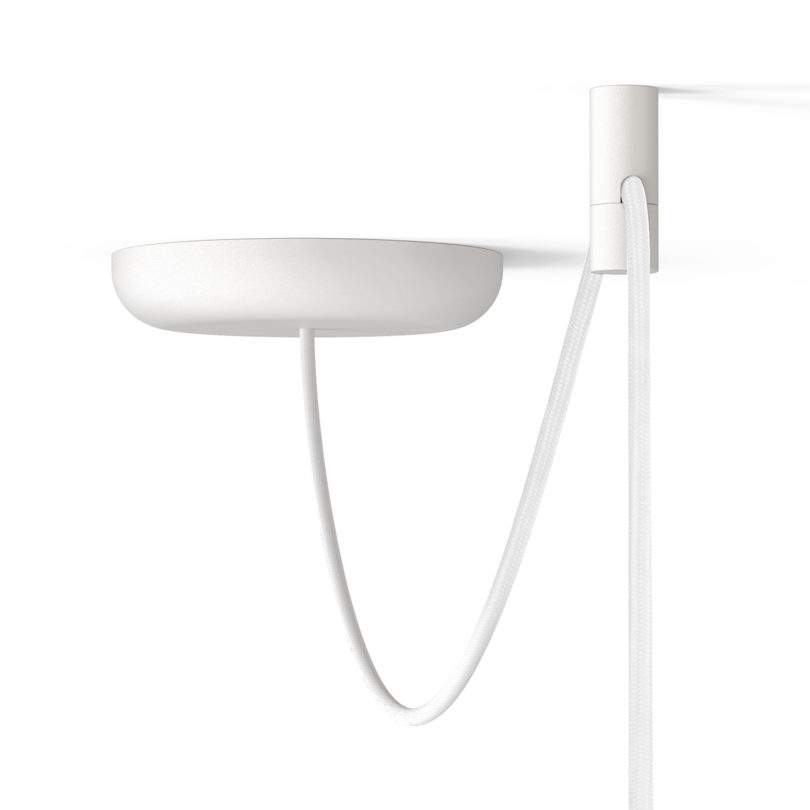 swagged suspended white disc-shaped pendant light on white background