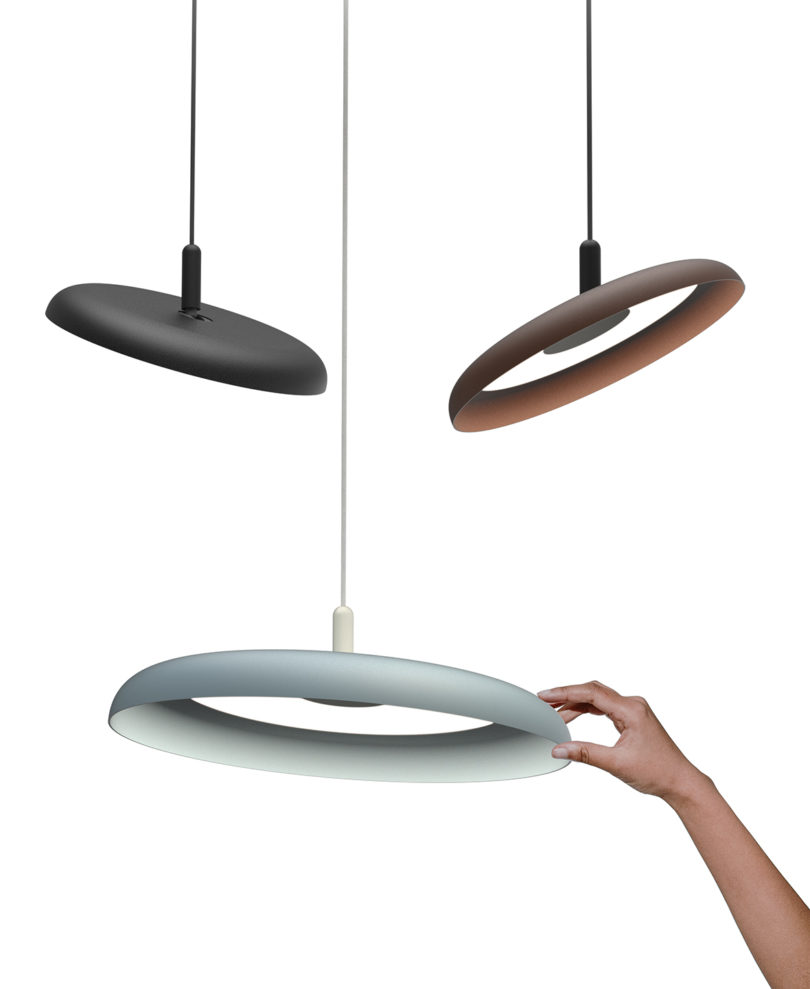three different colored disc-shaped pendant lights on white background