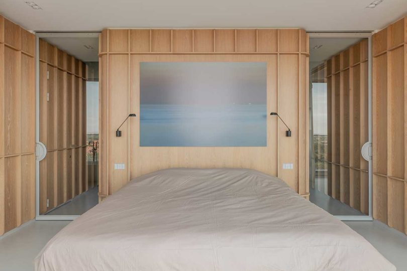 modern bedroom in penthouse with wood wall headboard