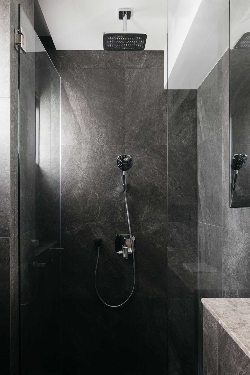 modern dark bathroom shower with gray tile