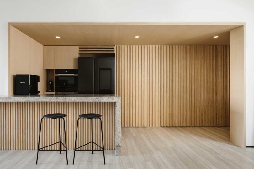 view into modern, minimalist kitchen in black and wood
