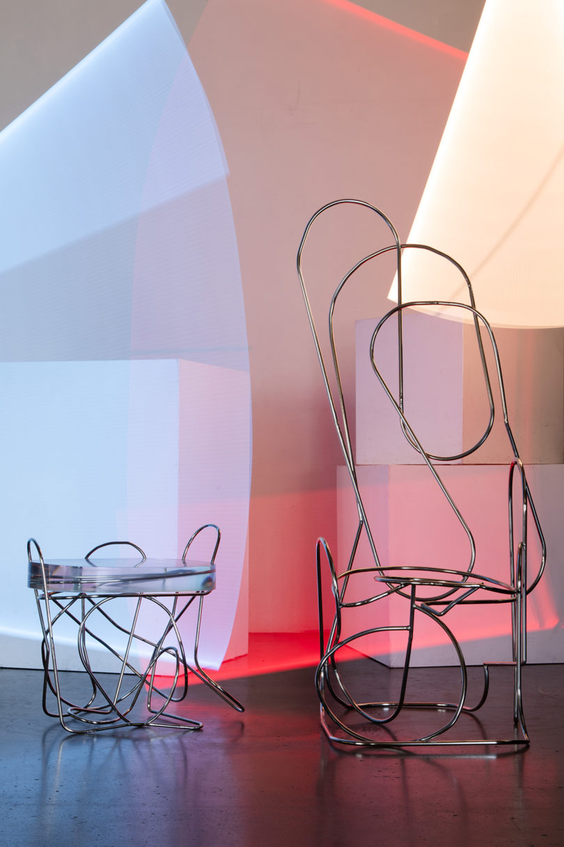 an abstract chair and side table made from hand-bent, welded steel