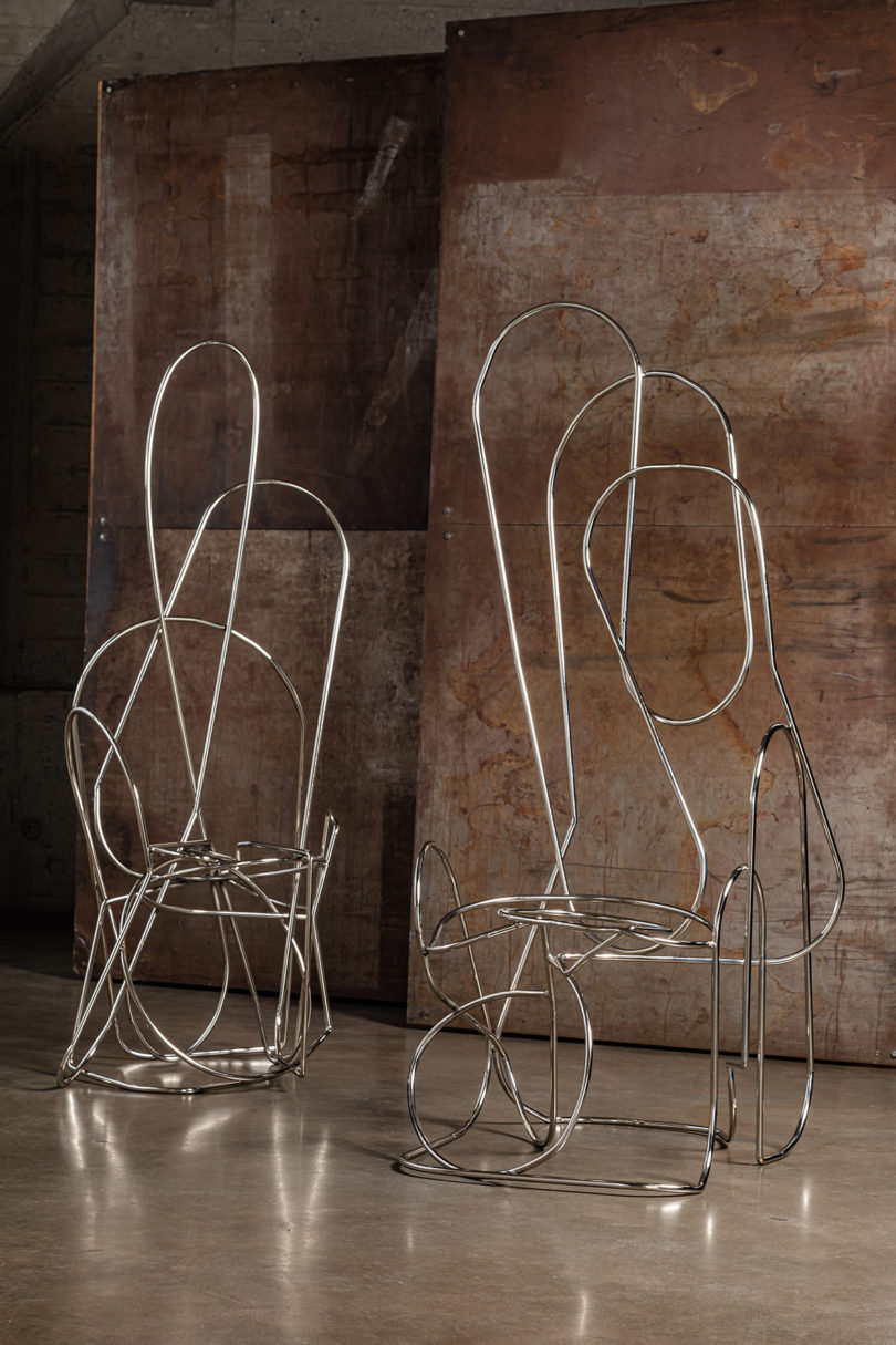 two abstract chair smade from hand-bent, welded steel