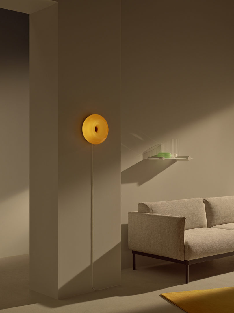 styled interior space with sofa and a donut-shaped wall sconce