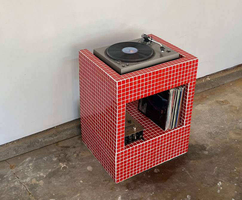 Amore Mio Red Vinyl Stand finished in 1-inch tiling, with Technics turnable and small collection of vinyl records.