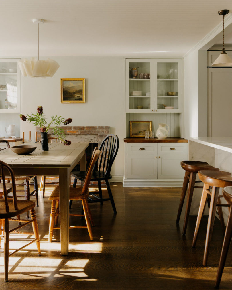 Antique opaline fixtures softly illuminate the kitchen, creating a cozy atmosphere.