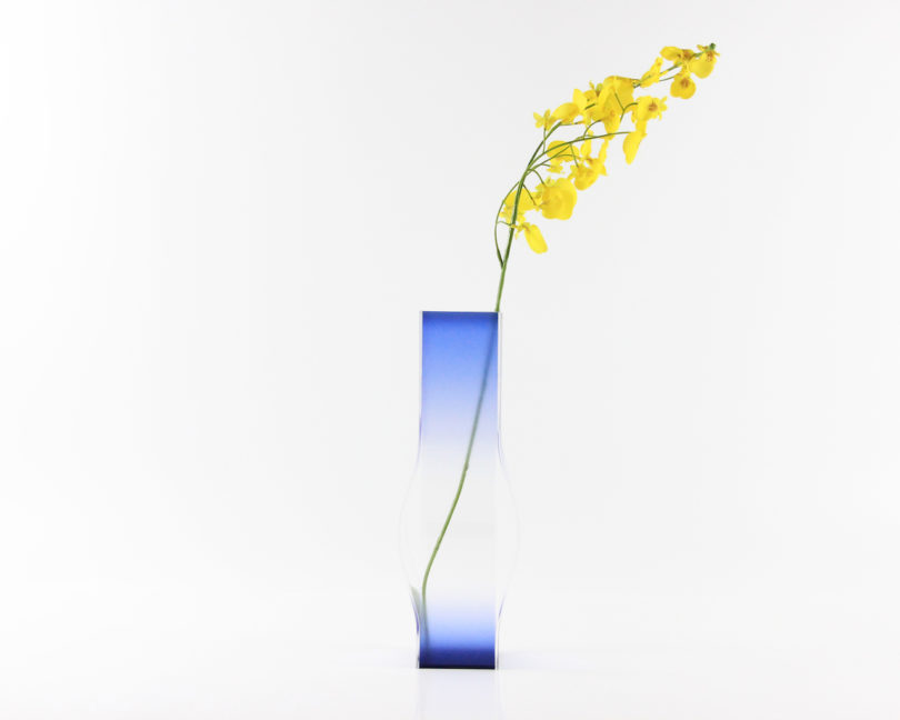 blue vase with yellow flowers