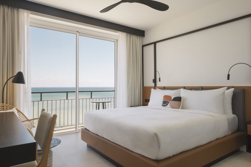 A guest bedroom with views of the ocean