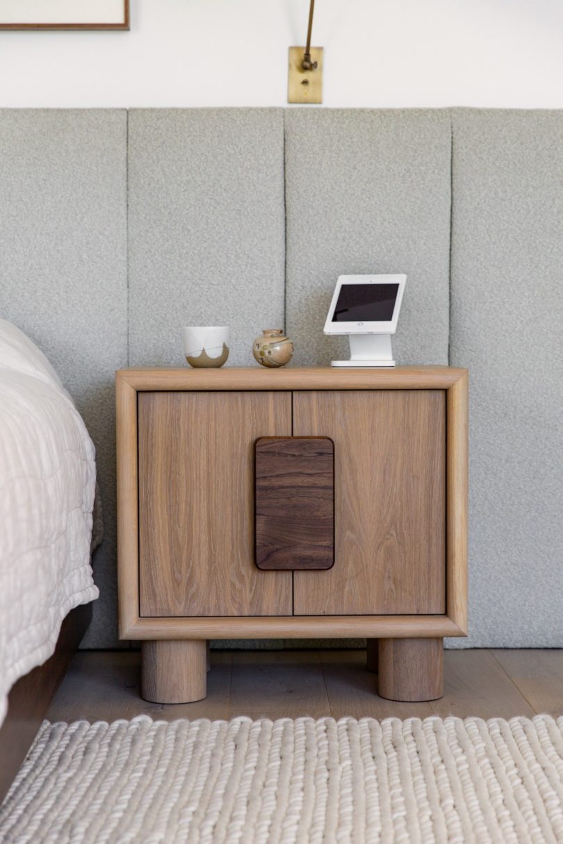 wooden nightstand in bedroom