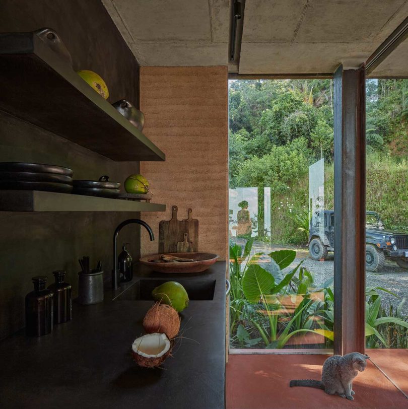 فضای داخلی مدرن با دیوارهای خاکی و قفسه های تیره آشپزخانه