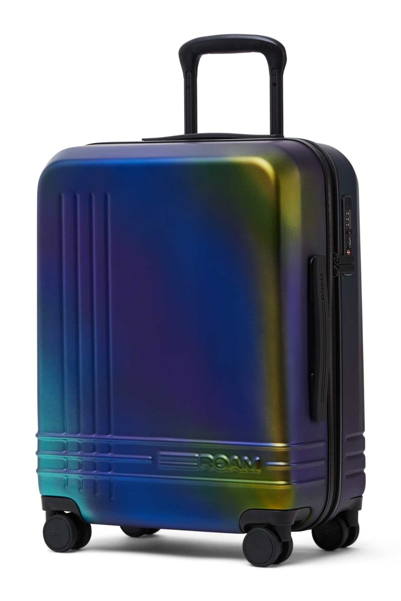 Angled view of iridescent blue green suitcase