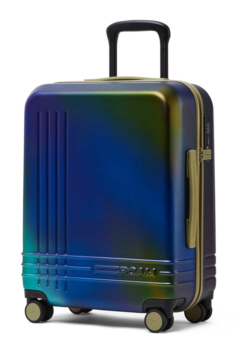 Angled view of iridescent blue green suitcase