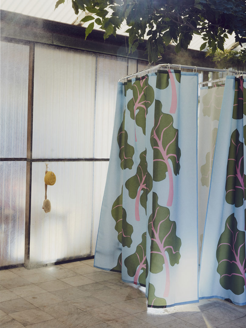 leaf patterned curtains surround an outdoor changing/shower space