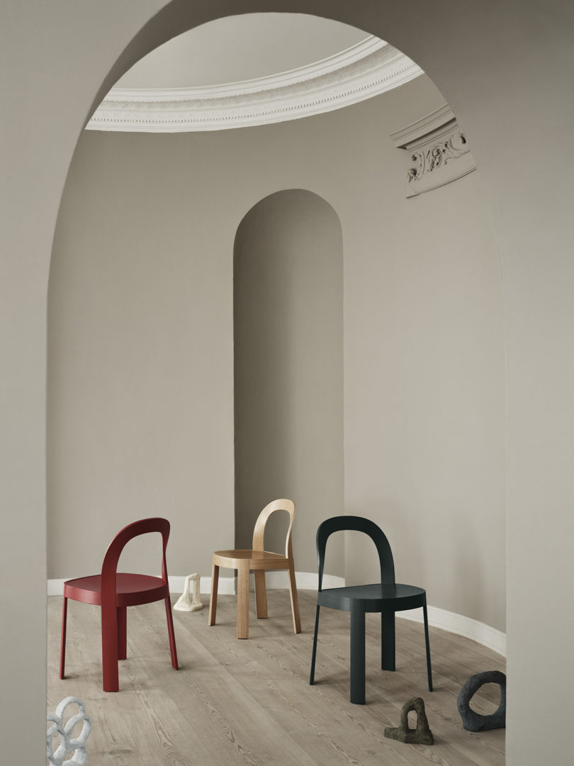 three modern chairs in an interior space
