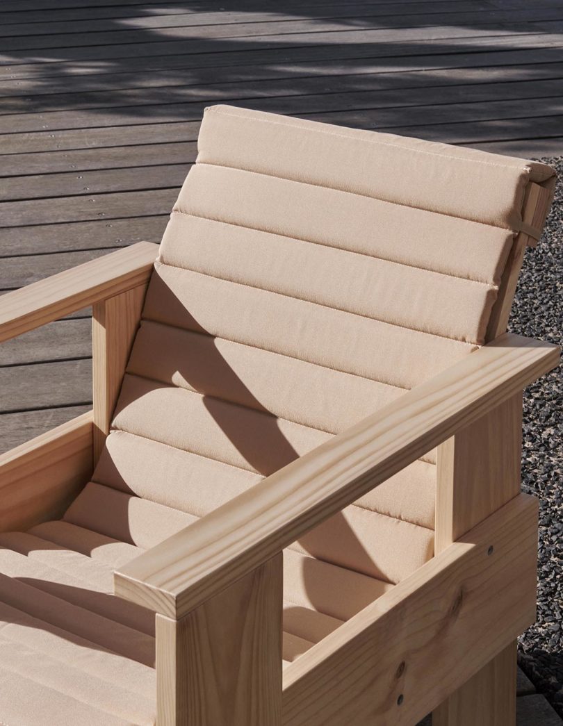 detail of wood outdoor chair with matching cushion