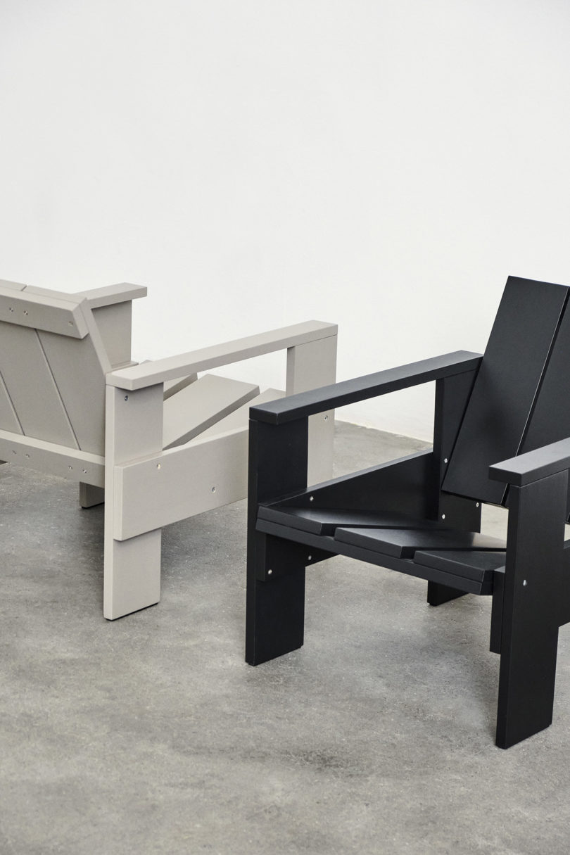 two wooden outdoor armchairs in an empty studio space