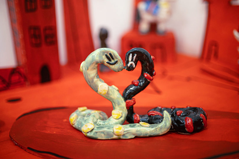 detail of two snakes in a scaled red model home