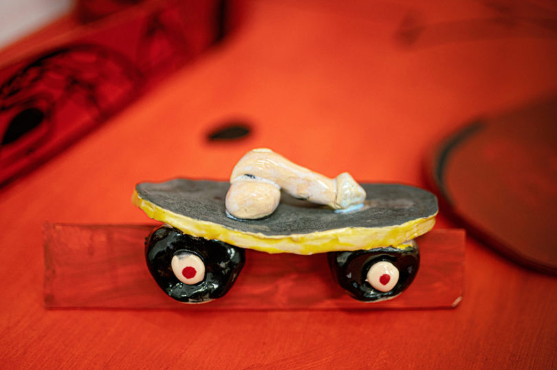 detail of penis on a skateboard in a scaled red model home